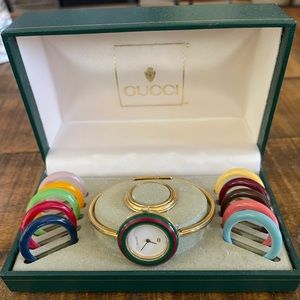 Gucci women’s watch with changeable bezels, including gold bezel